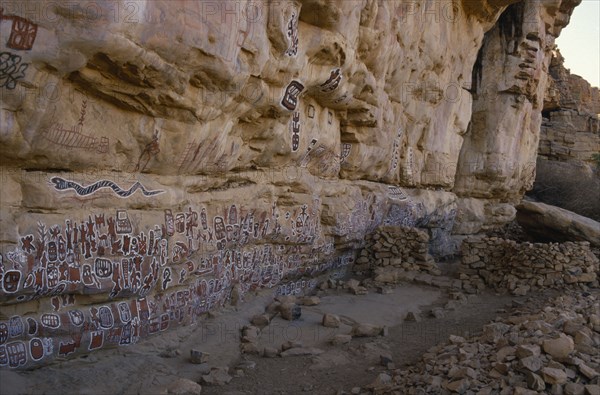 MALI, Bandiagara Escarpment, Songo Cave, Dogon rock paintings at sacred site of circumcision rituals which take place every three years.  Each new initiate adds his own personal symbol.