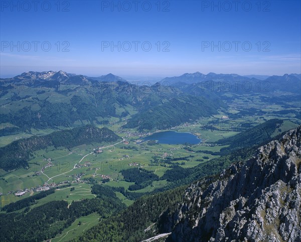 AUSTRIA, Pyramidenspitze, Kaisergebirge Mountains, "View North East from summit, Walchseed village in distant valley with lake."