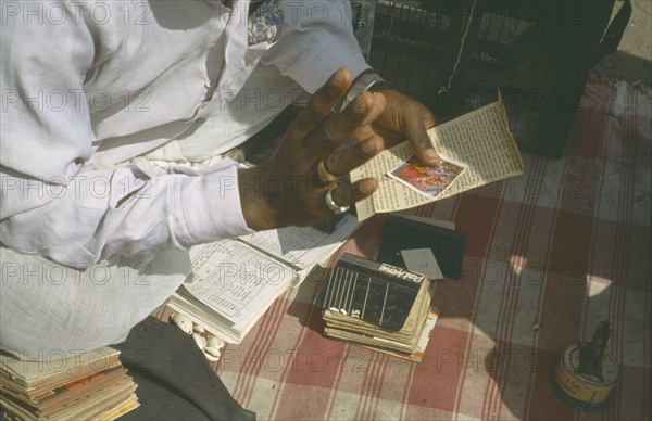 INDIA, Maharashtra, Pune, Cropped view of fortune teller.