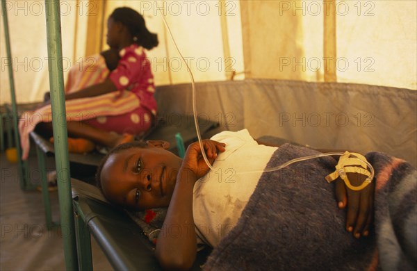 KENYA, Nairobi, Child on bed in emergency Cholera treatment tent in the Kisumu Ndogo slum area