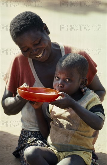 MOZAMBIQUE, Zambezia Province, Mugulama, Mother and child at feeding centre for displaced people run by World Vision Aid charity.