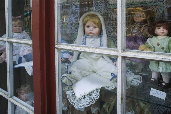 BELGIUM, West Flanders, Bruges, Assorted porcelain dolls in a shop window.