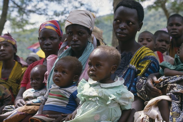 UGANDA, Orukinga Refugee Camp, Women listening to nutrition advice given to mothers with vulnerable babies at food distribution in refugee camp on the Rwandan border.