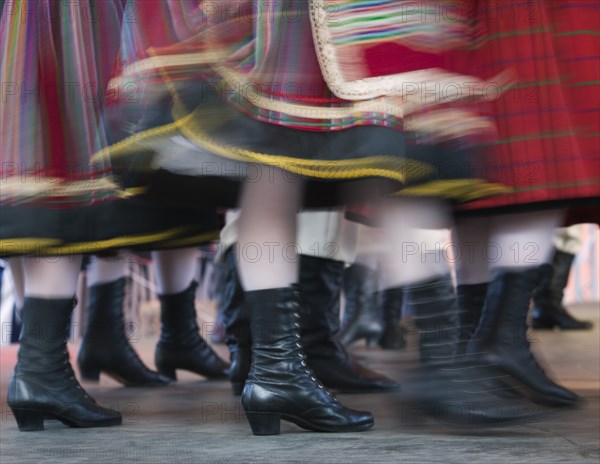 POLAND, Warsaw, "Detail of traditional dancers' costumes performing in the Old Town. Moving, blurred skirts and boots."