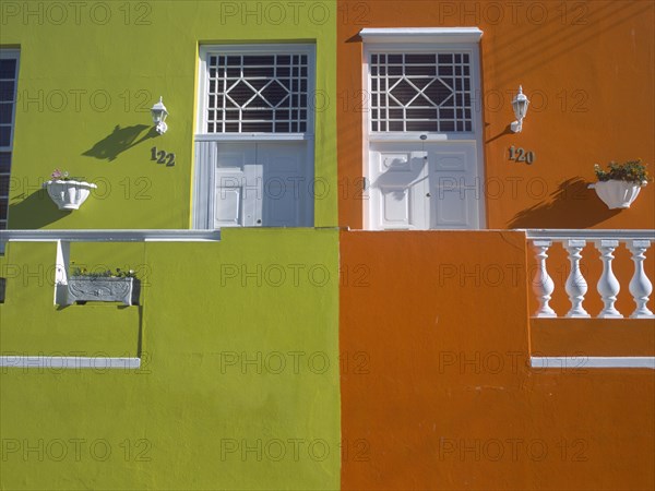 SOUTH AFRICA, Western Cape, Cape Town, Bo Kapp District. Chiappini Street. Brightly painted houses joined together with detail of doors.