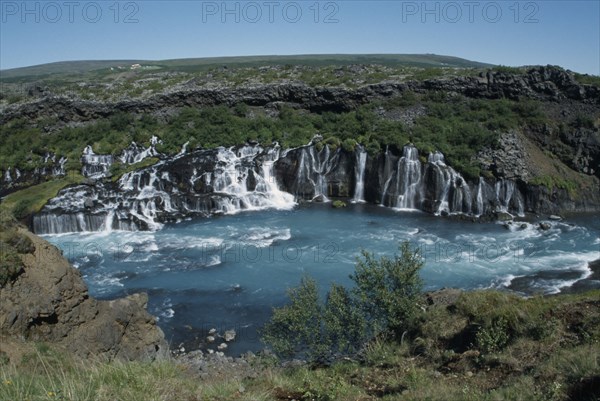 ICELAND, Borgarfjordur, Hraunfossar Falls on the Hvita River. Water comes from beneath Hallmundarhraun lava field.