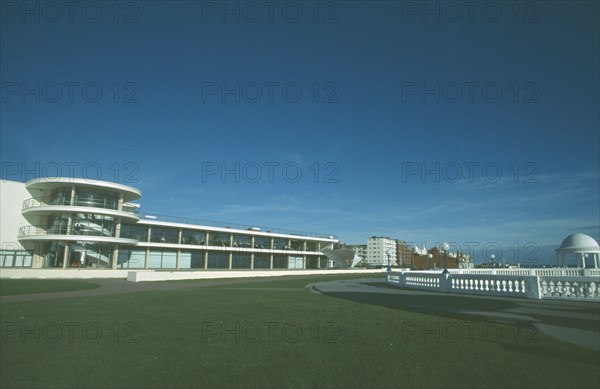 ENGLAND, East Sussex, Bexhill on Sea, De La Warr Pavilion. Exterior view from seafront over grass towards back entrance with staircase section and terracing.