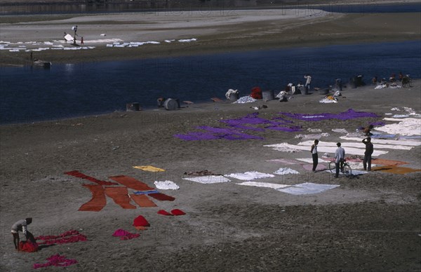 INDIA, Uttar Pradesh, Agra, Dyeing cloth in the Yamuna River.