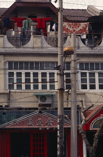 CHINA, Shanghai, Detail of Colonial architecture with washing hung out to dry on upper balcony.