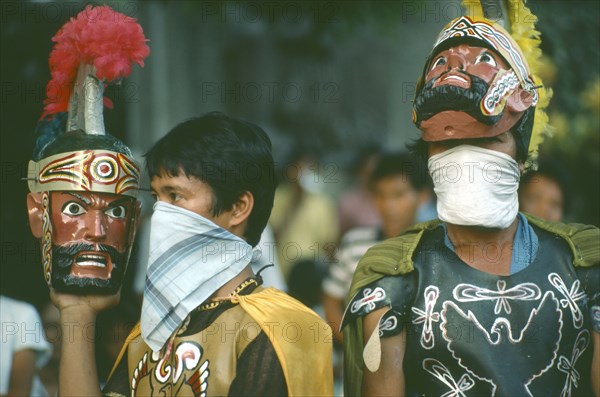 PHILIPPINES, People, "Two men in costume, one wearing and one carrying mask during the Ati-Atihan Festival."