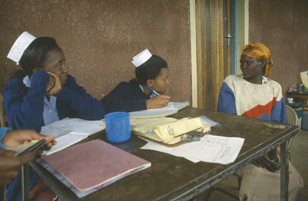 KENYA, Ortum, Nurses taking patient’s notes at Ortum hospital mobile clinic.