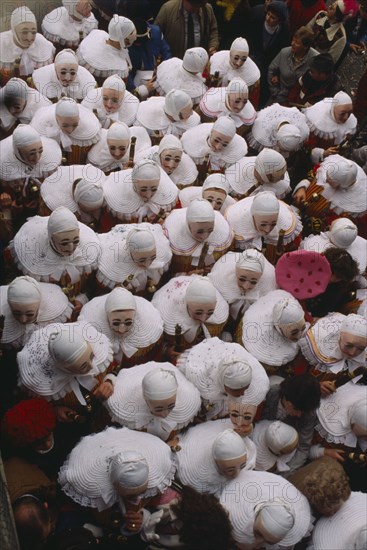 BELGIUM, Walloon Region, Binche, Les Gilles parade in medieval costume at carnival.