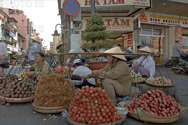 VIETNAM, South, Ho Chi Minh City, Fruit sellers on the street in the centre of town.