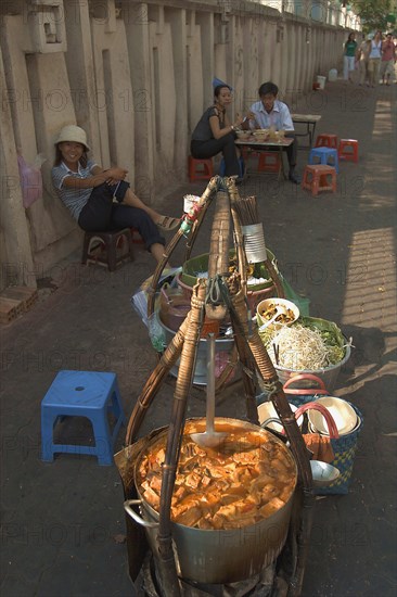 VIETNAM, South, Ho Chi Minh City, Sellers lined up against a wall selling food being from the street