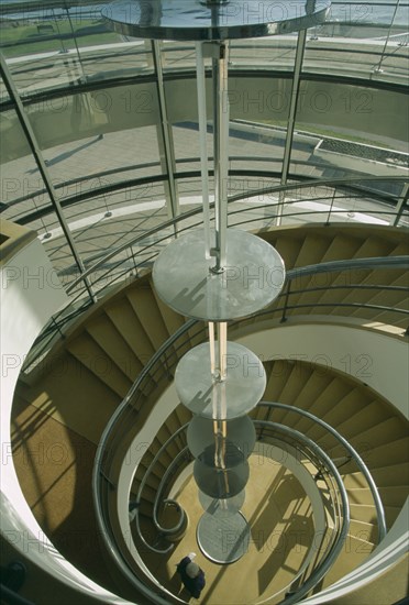 ENGLAND, East Sussex, Bexhill on Sea, De La Warr Pavilion. Interior view looking down the helix like spiral staircase and Bauhaus globe lamps