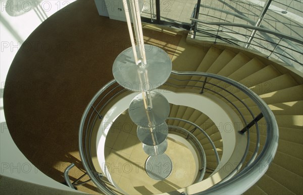 ENGLAND, East Sussex, Bexhill on Sea, De La Warr Pavilion. Interior view looking down the helix like spiral staircase and Bauhaus globe lamps.