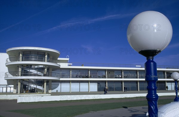 ENGLAND, East Sussex, Bexhill on Sea, De La Warr Pavilion. Exterior view over grass from the seafront terrace with globe shaped lamp.