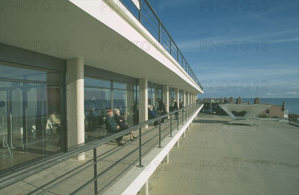 ENGLAND, East Sussex, Bexhill on Sea, De La Warr Pavilion. Exterior view of visitors on balcony terrace.