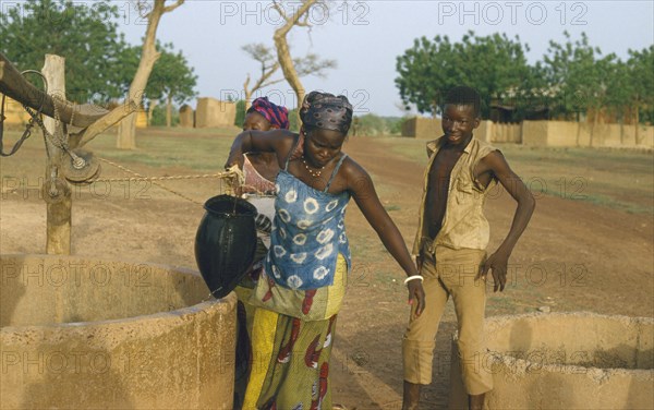 BURKINA  FASO, Kiembara, Women collecting water from a well