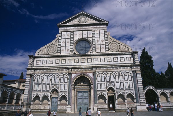 ITALY, Tuscany, Florence, Santa Maria Novella exterior facade with geometric design and central circular window.
