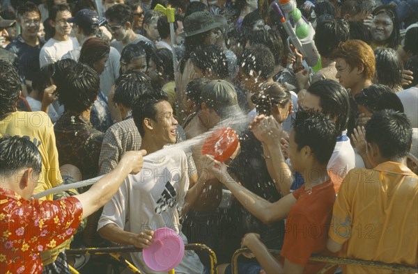 THAILAND, Bangkok, "Crowd having a water fight,  celebrating the Songkhran Festival. Thai New Year, 15 April."