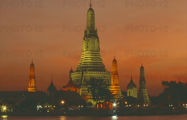 THAILAND, Bangkok, "Wat Arun, The Temple of  Dawn, on the bank of the Chao Phraya River, lit up at dusk."