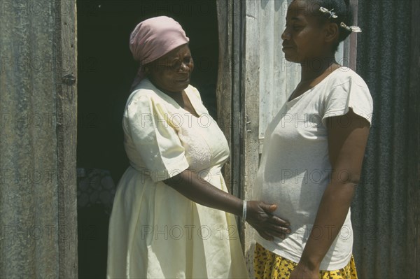 MAURITIUS, Rodrigues Island, Seventy year old traditional birth attendant with thirty five year old woman during her fourth pregnancy.