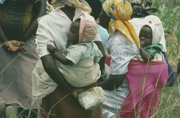 ZIMBABWE, Children, Carrying, Members of a woman’s agricultural co-operative  carrying their children on their backs.
