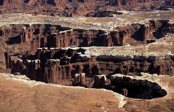 USA, Utah, Canyonlands National Park, "Hoodoos,  rock towers of eroding softer rock under hard cap rock at the White Rim sandstone bench in the north west of this spectacular park where the canyons of the Colorado and Green Rivers have dramatically eroded the Colorado plateau."