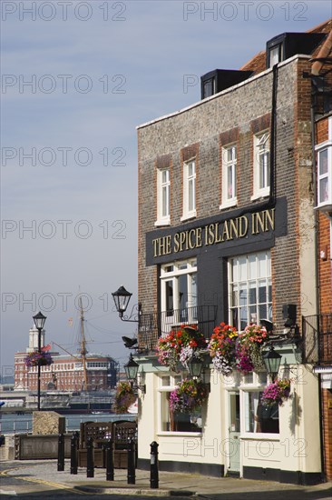 ENGLAND, Hampshire, Portsmouth, The Spice Island Inn at Old Portsmouth with HMS Warrioir and the Historic Dockyard beyond.