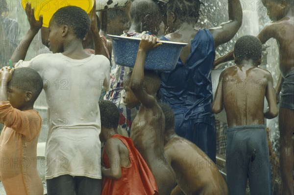 NIGERIA, Imo State, UNICEF water project.  Crowd of children with bowls.