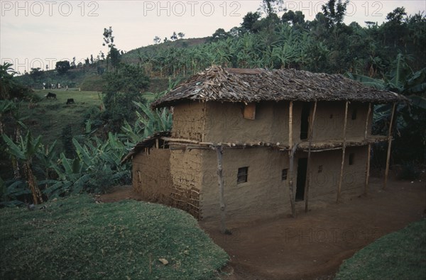 UGANDA, Traditional Housing, Two storey mud brick house with thatched roof in rural area near Mbale.