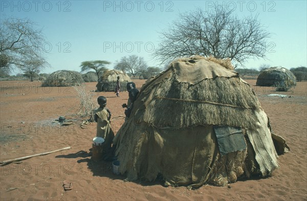 KENYA, North, Somali children outside domed hut.