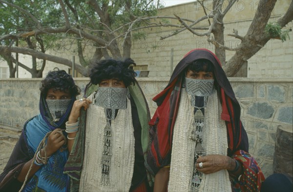 ERITREA, Massawa, Portrait of three Rashaida nomad women wearing embroidered veils and silver jewellery.