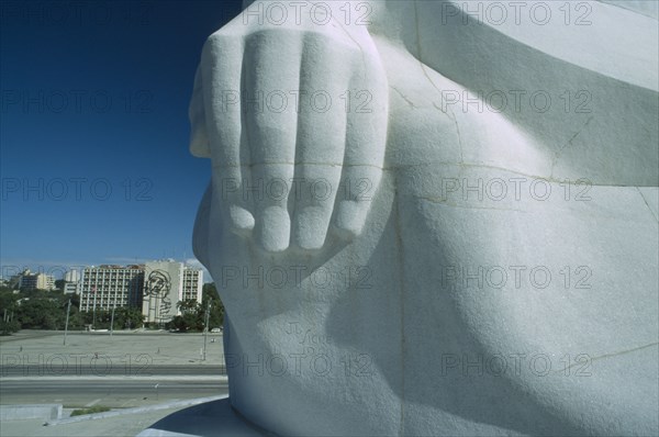 CUBA, Havana, Detail of the hand of the Jose Marti statue with the Revolution Square below and the Ministry of the Interior building in the distance with the Che Guevara mural.