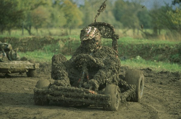 SPORT, Motorsport, Karting, Mud covered competitor in rally kart six hour charity endurance race held to raise funds for motor sports association for the disabled.