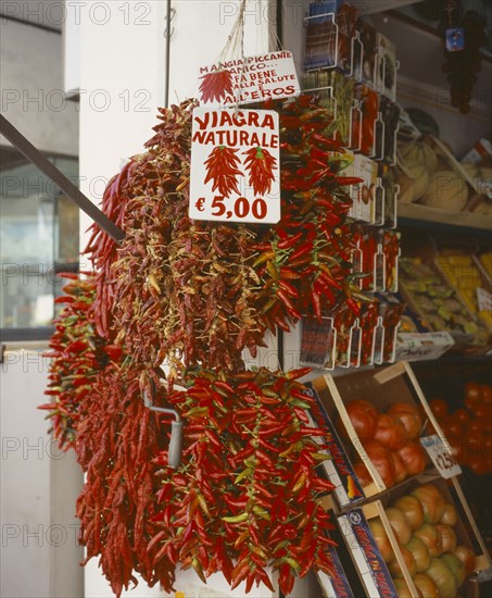 ITALY, Campania, Amalfi, "Via Genova, Main Street. Dried Chilli peppers hanging outside a shop. Sign says Natural Viagra."