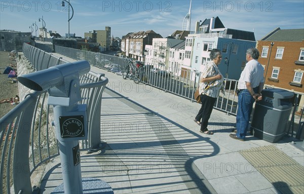 ENGLAND, Hampshire, Portsmouth, Old Portsmouth. People standing on path leading to the Square Tower with a Talking Telescope in the foreground