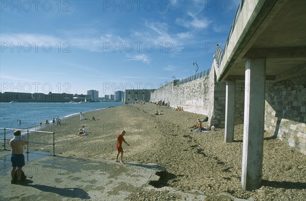 ENGLAND, Hampshire, Portsmouth, Old Portsmouth. Occupied strectch of beach next to the Walls looking towards the Square Tower.
