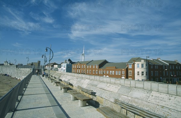 ENGLAND, Hampshire, Portsmouth, Old Portsmouth. Path with railings and seats next to the Walls and row of buildings to one side.