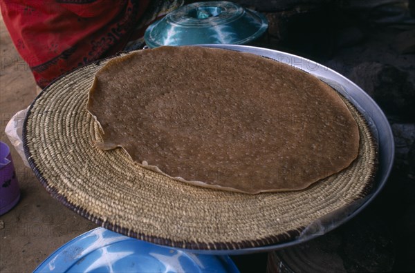 ERITREA, Asmara, "Deda camp for people displaced by war with Ethiopia.  Cooking injera a type of sour, flat bread that accompanies most meals."