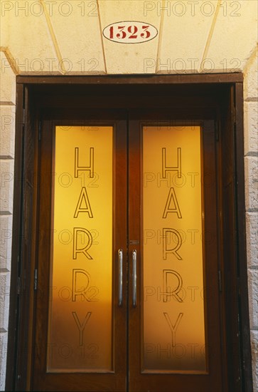 ITALY, Veneto, Venice, Door of Harry’s Bar with name etched on the frosted glass.