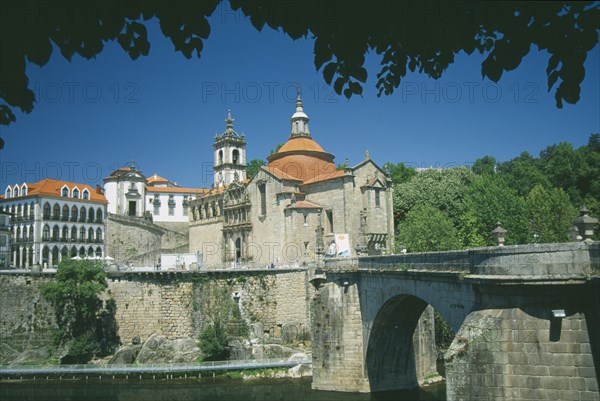 PORTUGAL, Porto, Amarante, Church of  Sao Goncalo.  Exterior view with the Ponte de Sao Goncalo across the River Tamega in the foreground part framed by trees.