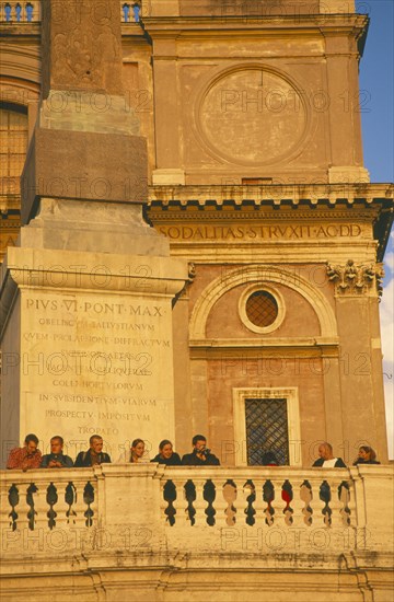 ITALY, Lazio, Rome, People watching sunset from Trinita dei Monti sixteenth century church at the top of the Spanish Steps.