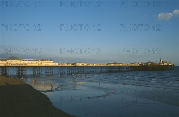 ENGLAND, East Sussex, Brighton, Brighton Pier in early evening light.