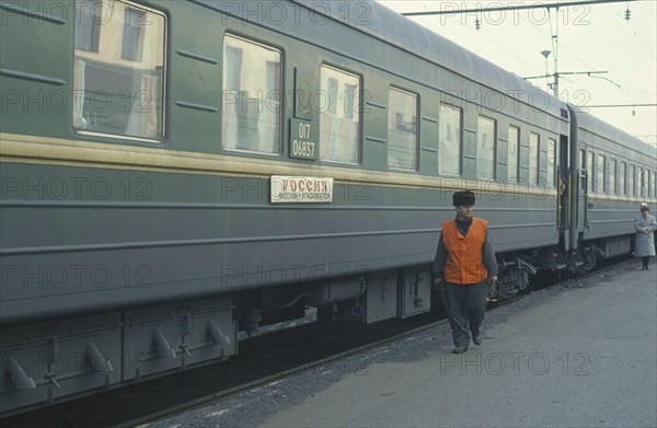 RUSSIA, Transport, Trans Siberian train and guard at platform of station.
