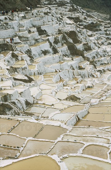 PERU, Cusco, Salineras, People working on the Salt Mines dating back to Inca times. Near Urubamba.