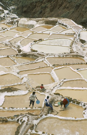 PERU, Cusco, Salineras, People working on the Salt Mines dating back to Inca times. Near Urubamba.