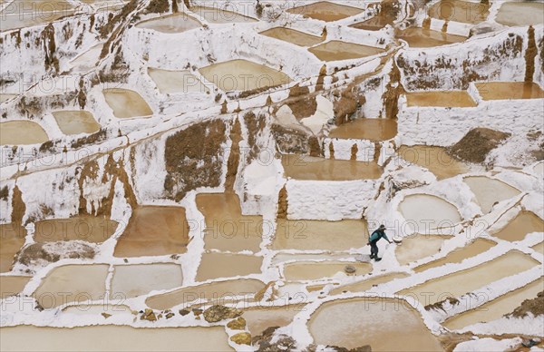 PERU, Cusco, Salineras, People working on the Salt Mines dating back to Inca times. Near Urubamba.