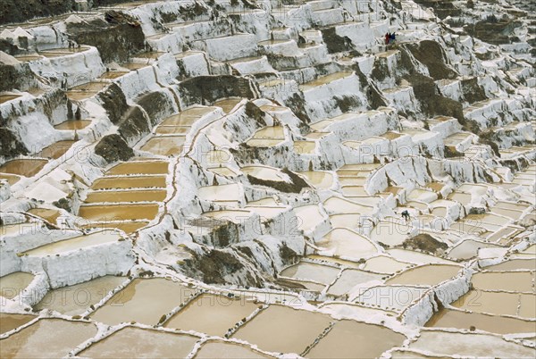 PERU, Cusco, Salineras, People working on the Salt Mines dating back to Inca times. Near Urubamba.